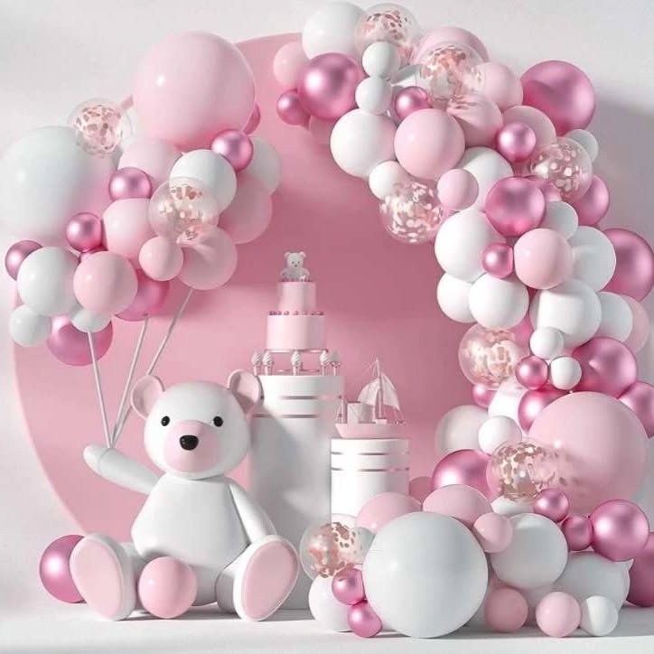 Pink and white themed baby shower decorations with balloons and teddy bear.