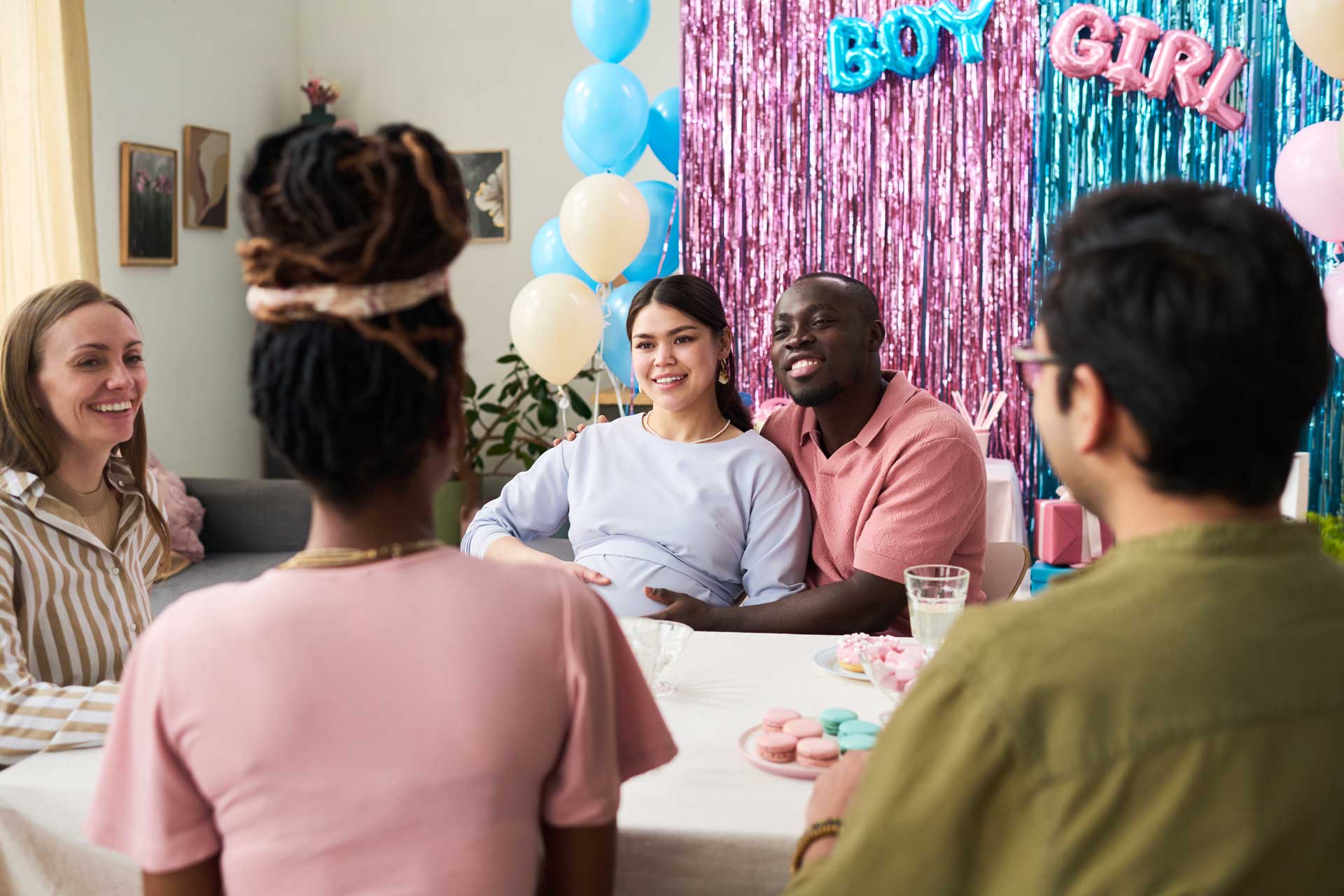 Baby shower celebration with themed party decorations, balloons, and party backdrop. Friends gathered for fun and joy.
