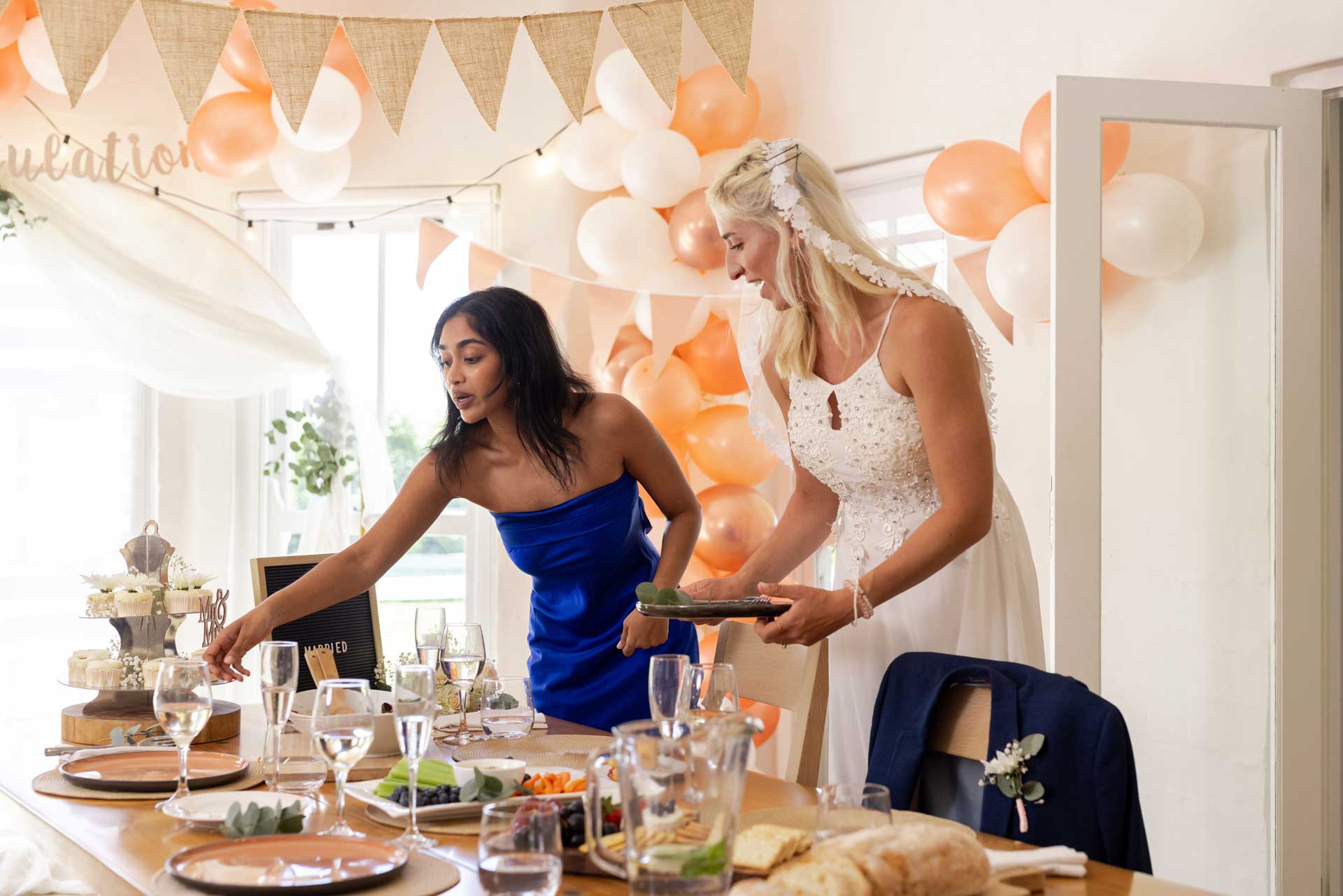 Wedding table setting with balloons and decorations, including tableware and party decor for a themed celebration.