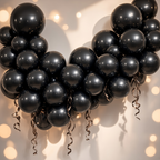 Party Paradise Store black metallic latex balloons arranged in a decorative arch with curled ribbons