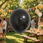 Party Paradise Store 12-inch metallic black latex balloon for party decorations in a festive outdoor garden setting