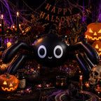 Party Paradise Store black spider Halloween balloon on a spooky table with pumpkins and candles
