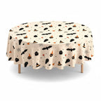 Party Paradise Store round Halloween table cover with a cream background and black bats, ghosts, and witch hats.