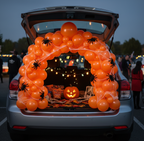 Party Paradise Store orange matte latex balloon arch decorated with spider webs and spiders for a Halloween trunk-or-treat