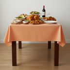 Party Paradise Store reusable orange plastic table cover on a dining table set with a festive meal