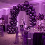 Party Paradise Store purple chrome latex balloons arranged in a large arch for an elegant wedding reception decor