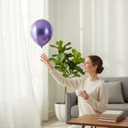 Party Paradise Store purple chrome latex balloon floating near a woman in a bright living room