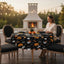 Party Paradise Store round Halloween tablecloth with jack-o'-lanterns and ghosts on a patio table setting