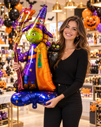 Party Paradise Store standing witch foil balloon with a black cat, held by a smiling woman in a festive party shop.