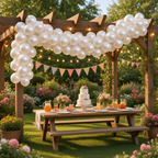 Party Paradise Store white metallic latex balloons arranged in a garland over a garden party table with a cake