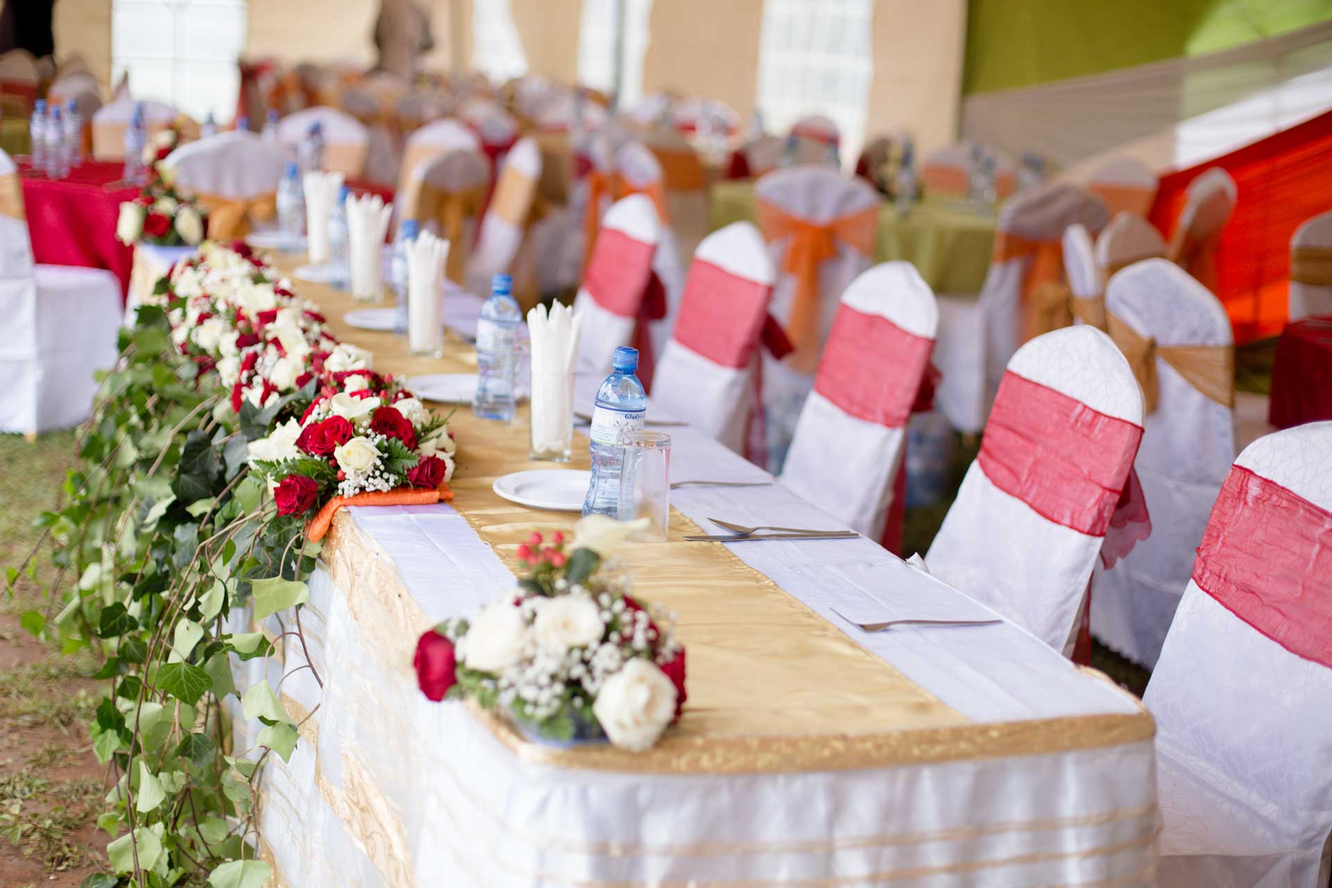 Elegant party table setup with flowers, party supplies, and tableware for a themed celebration event.